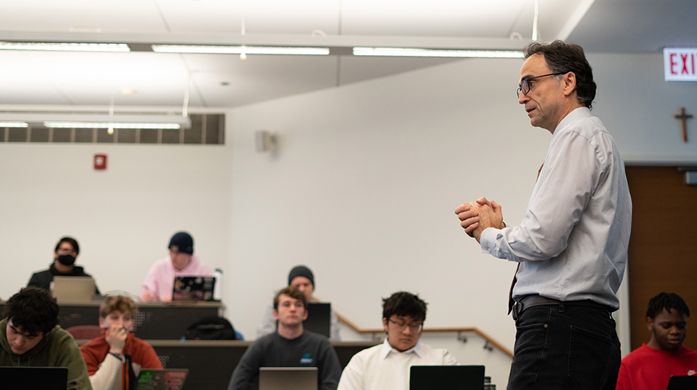 Nenad Jukic speaking in a full classroom